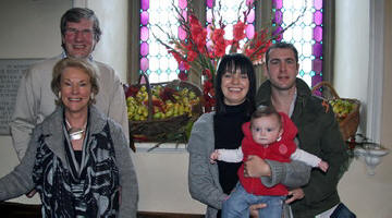 At Harvest Worship in Hillsborough Parish Church last Sunday morning (5th October) are Ballyworfy Poultry Farmers John and Liz McKee and their son Stephen, daughter-in-law Sharon and granddaughter Katie (6 months). They are pictured at the church window, which for the past 27 years, Liz has decorated for harvest thanksgiving.