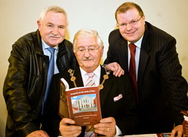 Former Tool Engineers Lisburn Mayor, Councillor Ronnie Crawford peruses the book. Looking on are former Tool Design Engineers John Kelly and Councillor Jonathan Craig MLA, who worked in the same department at Bombardier Aerospace.