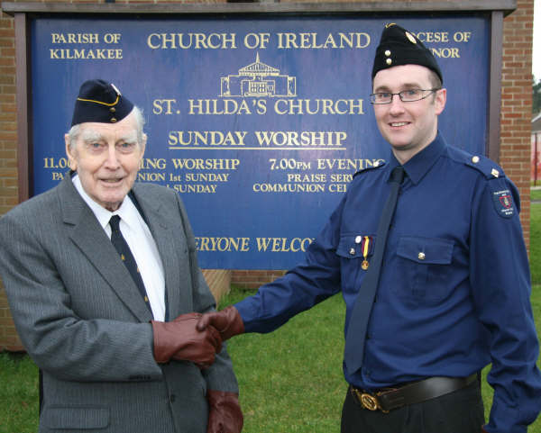 Martin Gillespie congratulates his 92-year-old grandfather, Major Edgar McIlroy, on 50 years service to St Hilda’s Church Lads’ and Church Girls’ Brigade. 