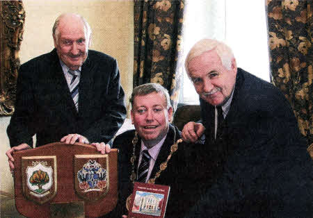 Bobby Howard (left), eldest son of the first Mayor of Lisburn, Alderman James Howard (1964-1970) shows Lisburn Mayor, Alderman Paul Porter a plaque which his father presented to Railway Street Presbyterian Church on Sunday, November 17 1968 to mark the centenary of Presbyterianism in Lisburn. Included in the photo is John Kelly (right) who presented the Mayor with a copy of his book entitled, `Footprints in the Sands of Time' which charts the history of Railway Street Presbyterian Church.