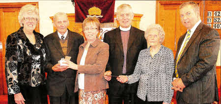 Rev Tom Harte, who is retiring after nine years as minister of Trinity Presbyterian Church, Boardmills, and his wife Audrey, were presented with gifts by, from left, June Kirkpatrick, Frank Fox, Anna Fox and Adrian Patterson, on behalf of the church. US2111-590cd