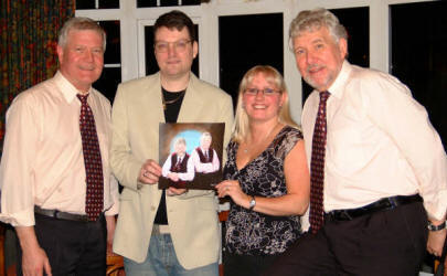 Local artist Jason Kelly is pictured presenting a painting of Bakerloo Junction to the band�s secretary Catherine O�Reilly at the Ivanhoe Hotel, Carryduff on Friday 1st December 2006. Looking on is Bakerloo Junction band members Drew Rowan (left) and Noel McMaster (right).