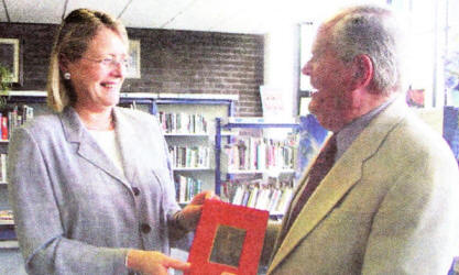 Principal of the Wallace High School Mrs Anne McBride accepting 'Six to a Loaf' from Ian Donaldson. US25-761SP