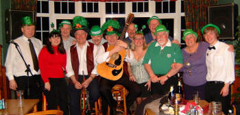 Drew Rowan (left) and Noel McMaster of Bakerloo Junction pictured with some of the many Irish music enthusiasts at a St. Patrick�s night party in the Ivanhoe Hotel, Carryduff, last weekend.