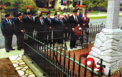Members of Lisburn Royal British Legion laying a wreath at the memorial to the 16th Division
