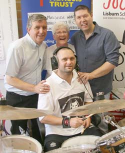 Record breaker Allister Brown pictured with his parents Nigel and Maureen and Stephen McLoughlin (right) of Music Matters who hosted the event.