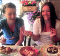 Laura Neill and Louise Shortt sample snails and frogs' legs at a local restaurant.
