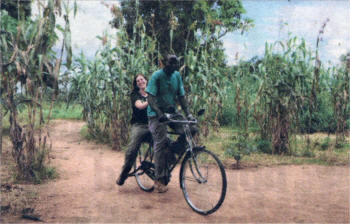 On YOUR BIKE...Kagwa Christopher, who has returned to his home in Mucwini, northern Uganda, gives Dublin singer-songwriter Eleanor McEvoy a lift on the bicycle he recieved from Oxfam. Bicycles are among the Oxfam Unwrapped gifts for Christmas 2008.