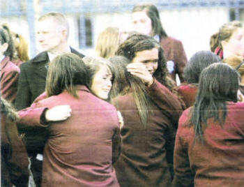 Ciara's school friends wait for her cortege to reach the Church of Our Lady Queen of Peace.