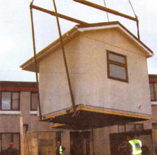 The 'Pod' is lowered into place at the rear of the house in Hillhall estate.