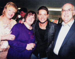 Keith Duffy of Boyzone pictured with Maureen , Donna and John McConnell at Lisburn Adult Resource Centre. US3709-101A0 Picture By: Aidan O'Reilly