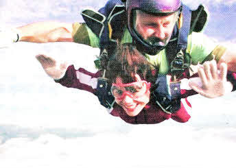 Venture Photography's NI Manager Julie McBride is snapped hurtling earthwards with instructor Steve Kerr on a tandem sky dive for the TinyLife premature baby charity.