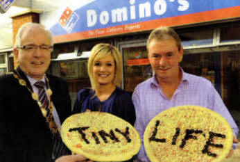 Lisburn City Council Mayor, Councillor Allan Ewart; Mrs Samara Prentice, Community Events Officer, Tiny Life with Mr Adrian Caldwell, Owner of Domino's Pizza, Lisburn.