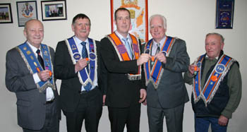  Proud father Bro William Finn receives his 50-year jewel from his son, Bro Alan Finn, Worshipful District Master of Hillsborough District LOL No 19.  Also presented with the long service award were Bro Kenneth Riddle and Bro Robert Finn (left) and Bro Harry Riddle (right).