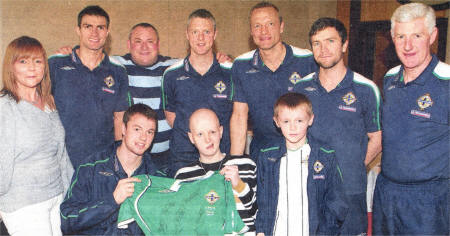Stephen receives a signed Northern Ireland shirt from hero Jonny Evans. Also pictured is Stephen's mum Ann, Stepfather Mark and brother Deen with members of the Northern Ireland squad, including Aaron Hughes, Stephen Craigan, Maik Taylor, Damien Johnson and Manager Nigel Worthington. 