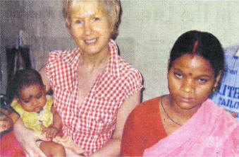 Bernie with a mother and daughter in the HIV Clinic. It not yet known the little girl HIV positive he cannot tested until she 18 months old.