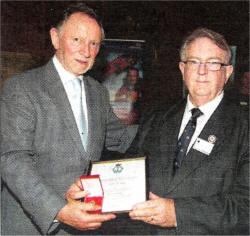 Bill Clarke receives his Bronze Badge from Phil Coulter.