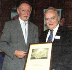 Neville Latham receives his award from Phil Coulter.