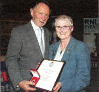 Anne Gray receives her Silver Badge from Phil Coulter.