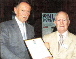 Phil Coulter presents the certificate to the Grent Trust. 