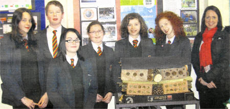 Year 9 Friends' pupils with their Pug Hotel'. From left — right are: Emma Hassard, Caplan Harkin, Sophie Jameson, Emily Joyce, Caroline Finney, Chloe Hassard and teacher Dr. Collins. 