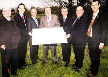 Jimmy Millar Lisburn North Community Association, MLA Paul Givan, Alex Atwood Minister for Social Development, John Garland Ulidia Housing Association, Councilor William Leathern and Minister For the Environment Edwin Poots study the plans. US441O-115A0