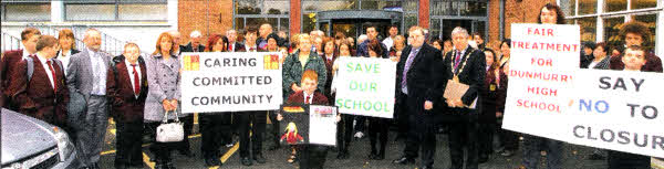 Jonathan Hamill, a student at Dunmurry High School, presents a petition to the South Eastern Education and Library Board opposing the potential closure of his school. Supporting the campaign to keep the school open are the Mayor of Lisburn, Councillor Brian Heading, elected representatives from the Dunmurry area, students, parents and teachers of Dunmurry High School.