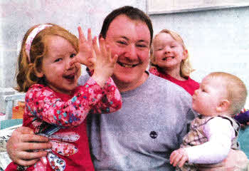 Tim Hodkinson with his children Emily, Clara and Alice.