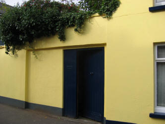 This picture shows the high wall and entrance to the Friends burial ground in Railway Street.