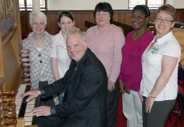 Choirmaster Louis Irvine (seated at organ) pictured in April 2009 with Dundrod Presbyterian Church Choir members L to R: Alison McClure, Barbara McClure, Patricia Calvert, Veronica Grant and Linda McCullough.