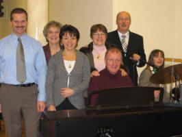 The Praise Team at the Church of God, Dunmurry. L to R: Robert Newberry, Helen Marks, Joanne Murdock, Jean Spencer, David Spencer, Pastor David Spence and Tracey Newberry.